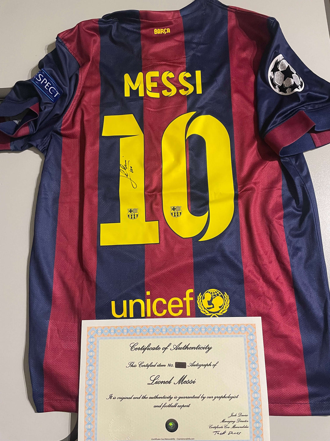 Lionel Messi signed 2015 Champions League final jersey with certificate of authenticity, showcasing iconic football memorabilia.