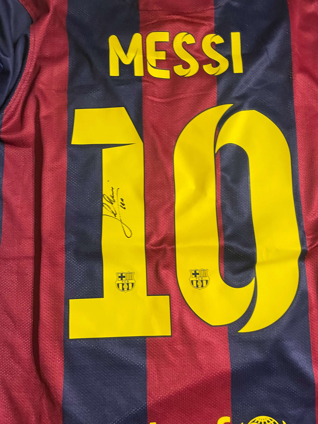 Lionel Messi signed 2015 Champions League final jersey, featuring his iconic number 10 and autograph.